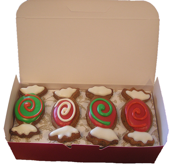 Hand-decorated gourmet dog cookies with natural yogurt frosting and vegetable-based food coloring, artisanal grain-free treats for dog birthdays.