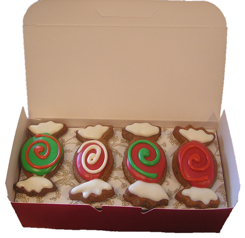 Hand-decorated gourmet dog cookies with natural yogurt frosting and vegetable-based food coloring, artisanal grain-free treats for dog birthdays.